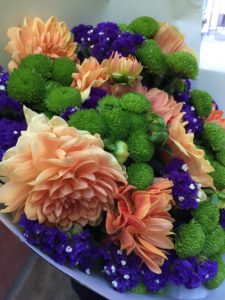 Orange, green and purple flowers that I bought to take to a friends for dinner. 